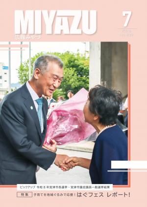 市長が花束を受け取り握手している様子